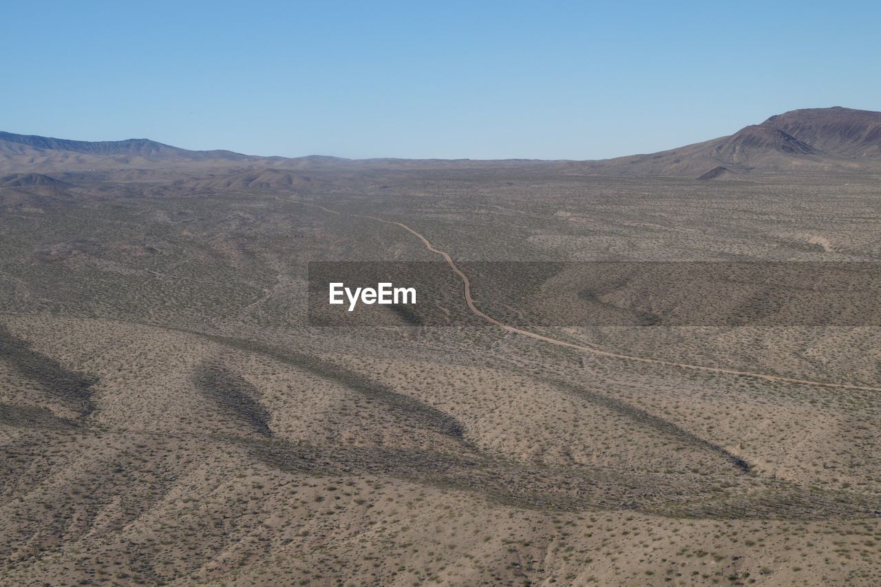 Scenic view of desert against clear sky