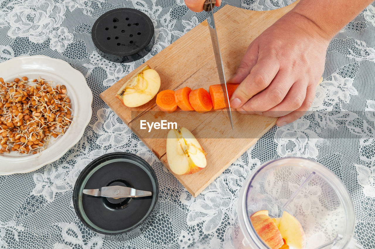 HIGH ANGLE VIEW OF MAN PREPARING FOOD