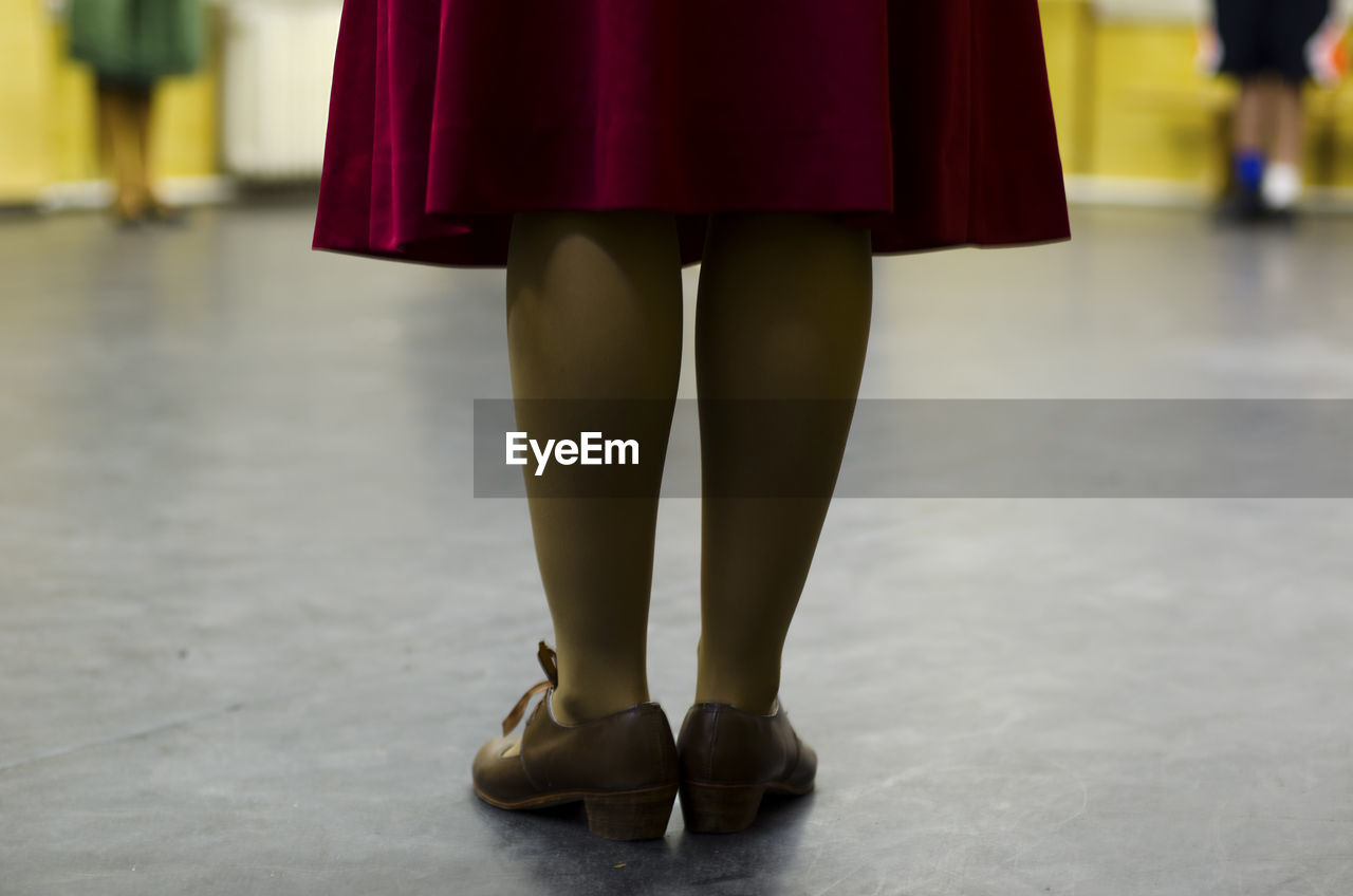 Low section of woman standing on floor