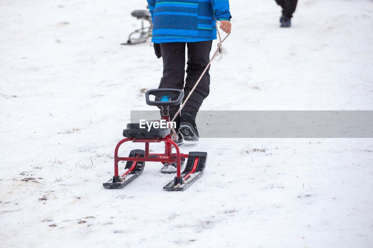 low section of man skiing on snow