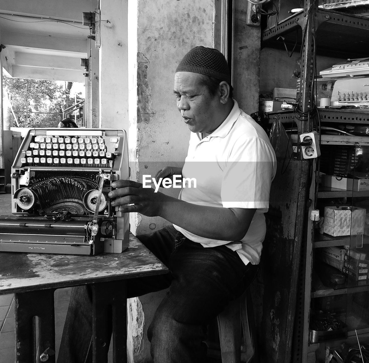 Man repairing typewriter