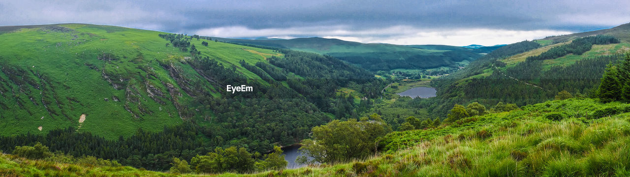 Panoramic view of mountains against cloudy sky