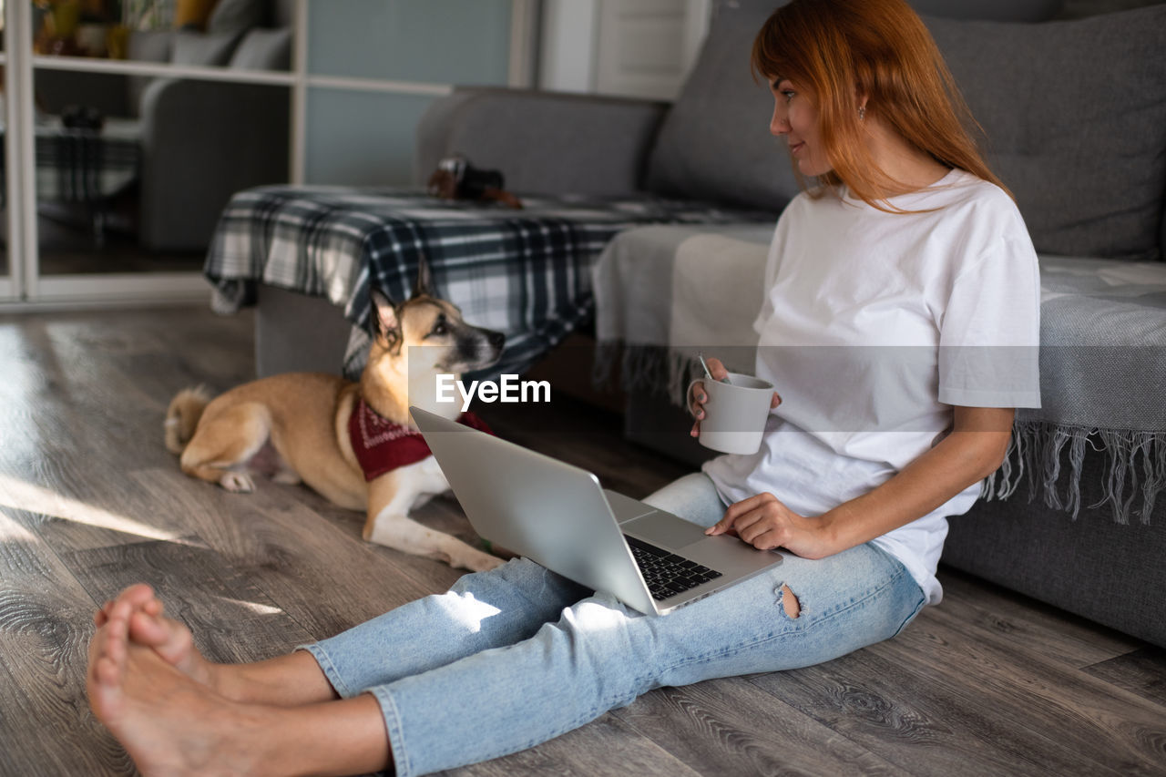 Dog owner retouching photos on laptop