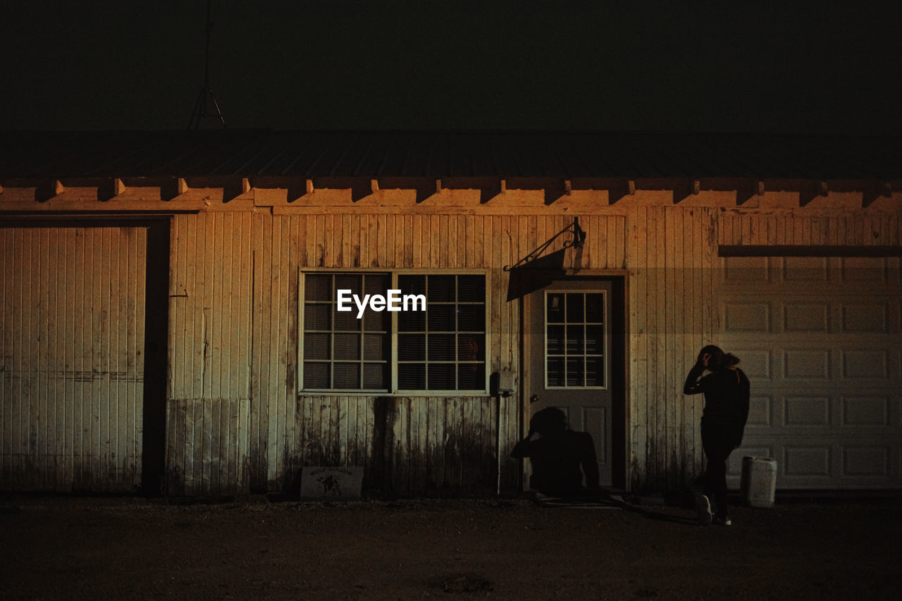 People standing outside building at night