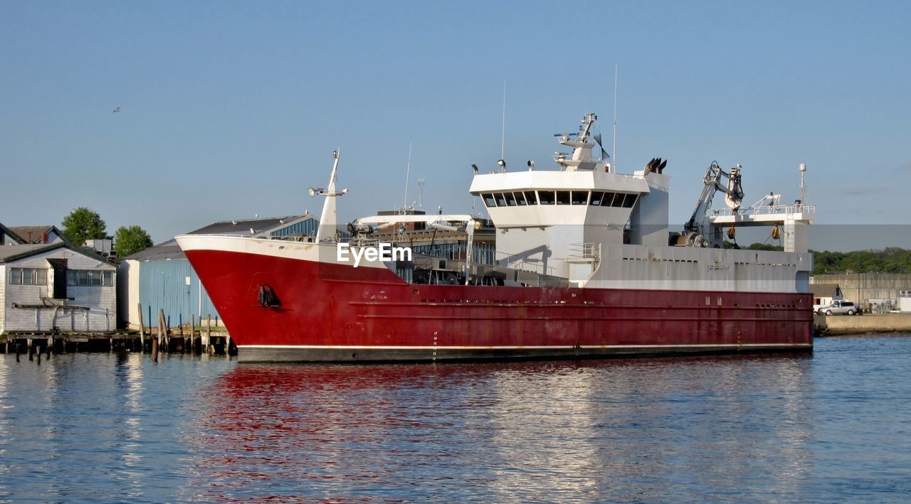 SHIP MOORED AT HARBOR