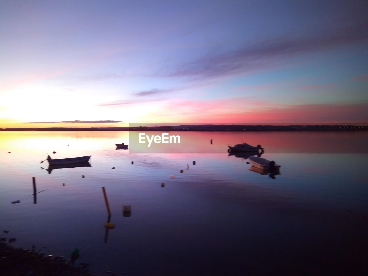 water, sky, reflection, sunset, beauty in nature, dawn, tranquility, scenics - nature, sea, nature, tranquil scene, horizon, cloud, no people, horizon over water, idyllic, evening, nautical vessel, beach, outdoors, sun, environment, silhouette, non-urban scene, transportation, orange color, land, landscape, sunlight, shore, ocean, dramatic sky, twilight, travel destinations