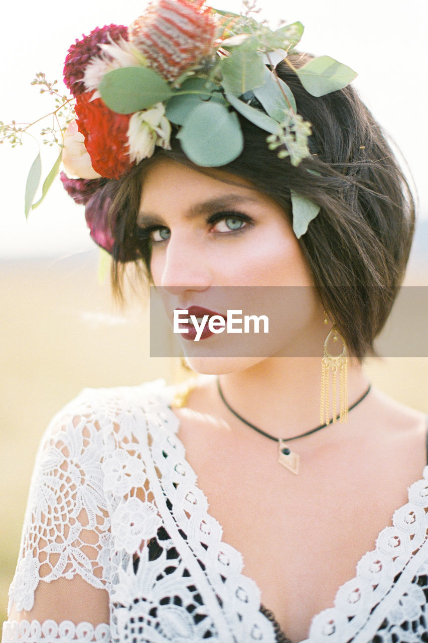 close-up of young woman wearing flowers