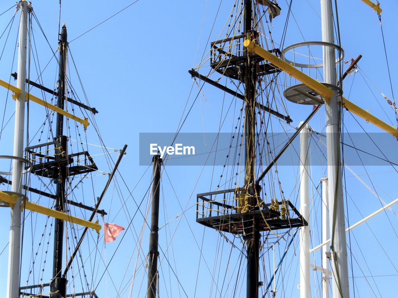 sailboat, nautical vessel, sailing, vehicle, ship, pole, mast, transportation, sky, mode of transportation, sailing ship, tall ship, nature, sea, water, rope, rigging, no people, watercraft, blue, overhead power line, outdoors, history, galleon, day, clear sky, passenger ship, the past, barquentine, low angle view, windjammer, travel, architecture, boat, electricity, sunny