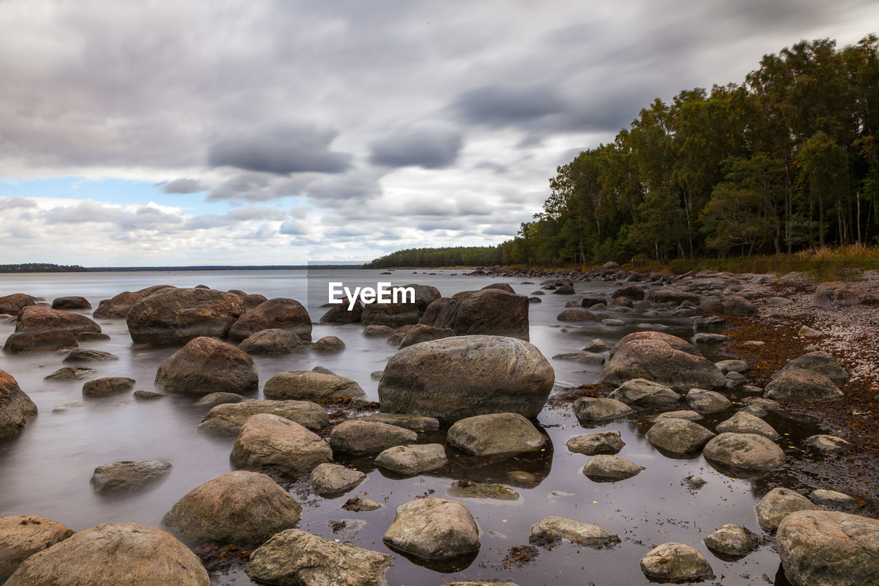 Rocks in sea against sky