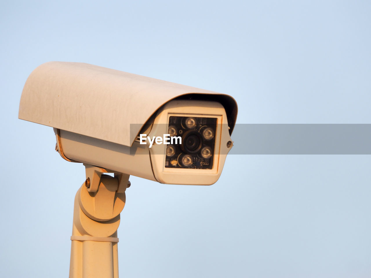 Close-up of security camera against clear sky