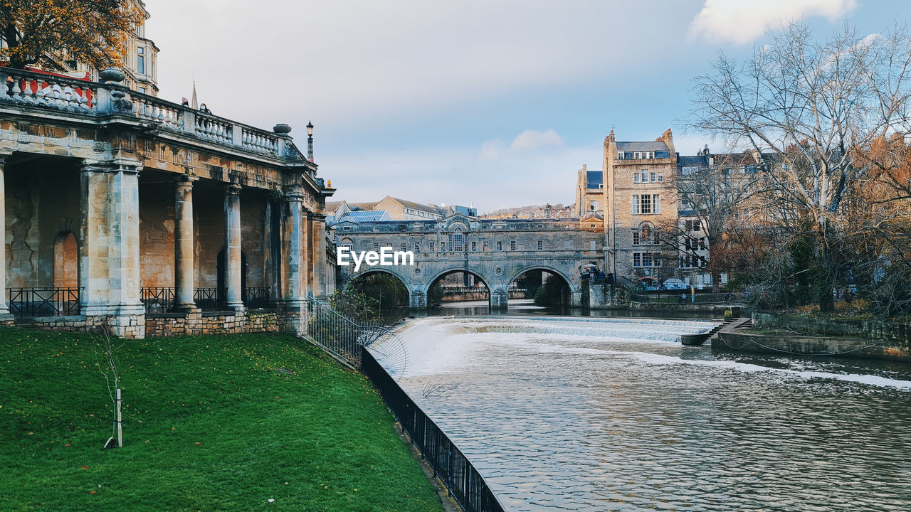 architecture, built structure, building exterior, water, river, travel destinations, sky, nature, bridge, waterway, history, the past, travel, cloud, city, tourism, cityscape, landmark, building, town, plant, no people, tree, reflection, outdoors, old, transportation, urban area, environment, day, landscape, château, estate, arch