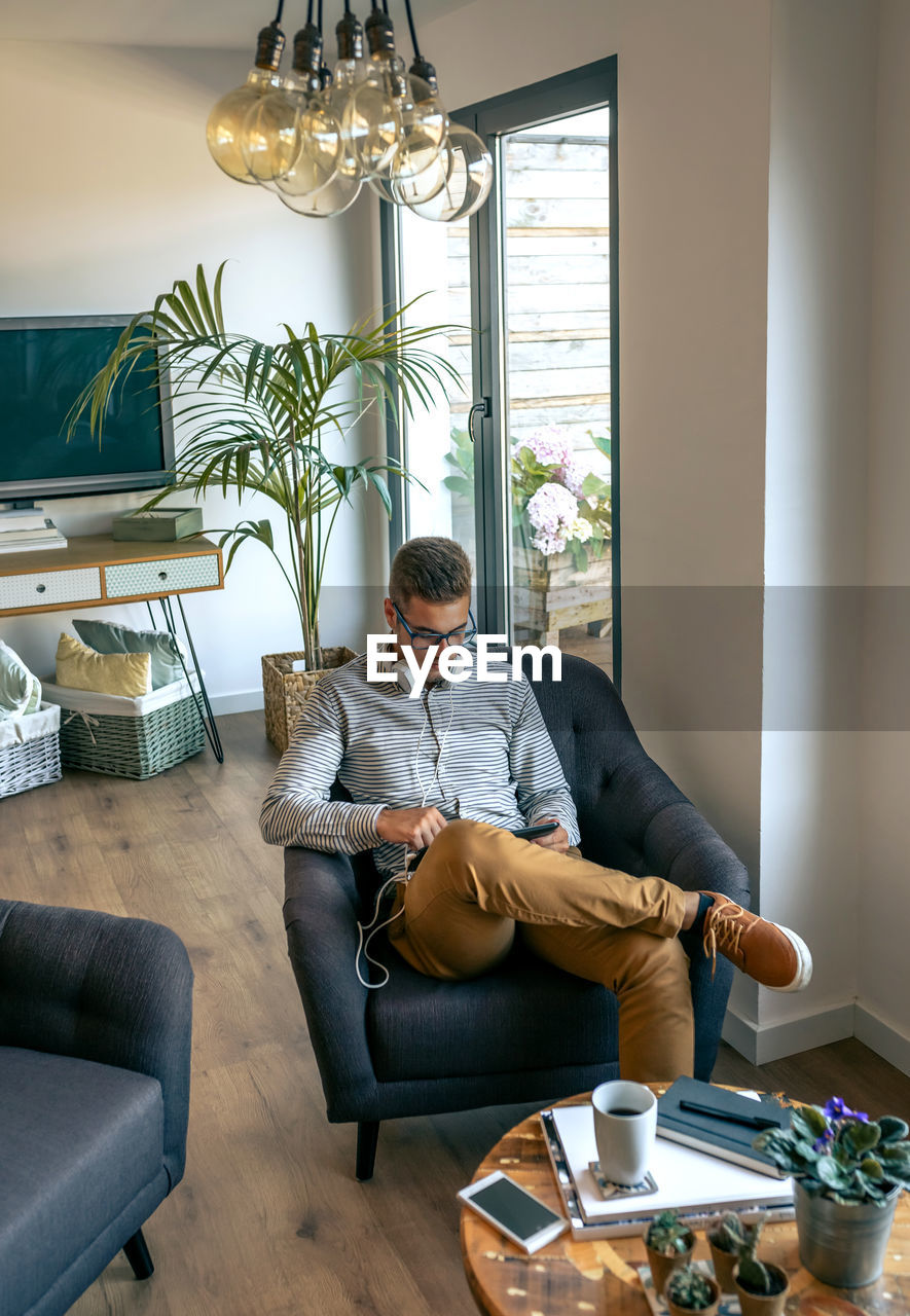 Young man sitting on sofa