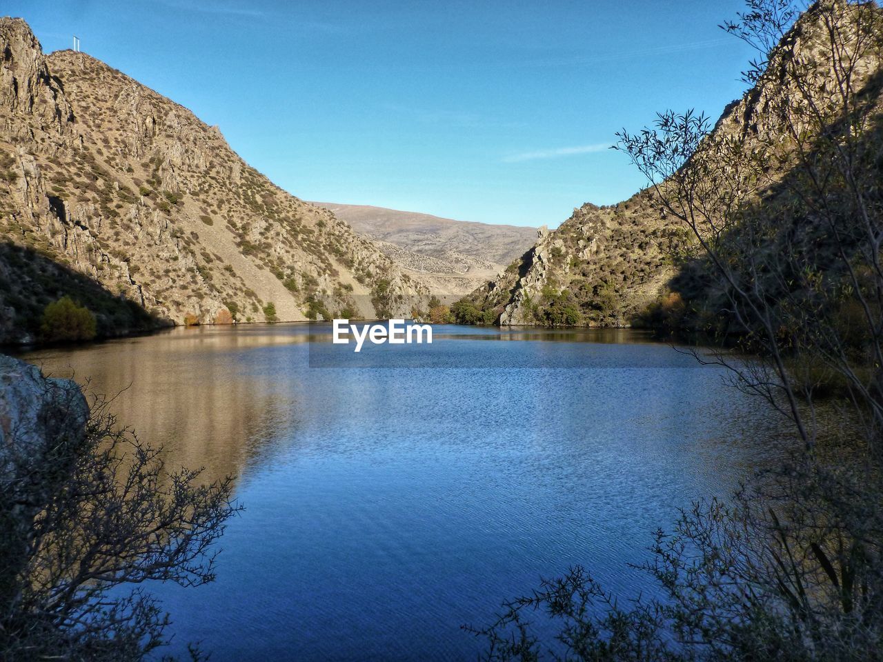 Scenic view of lake and mountains against sky