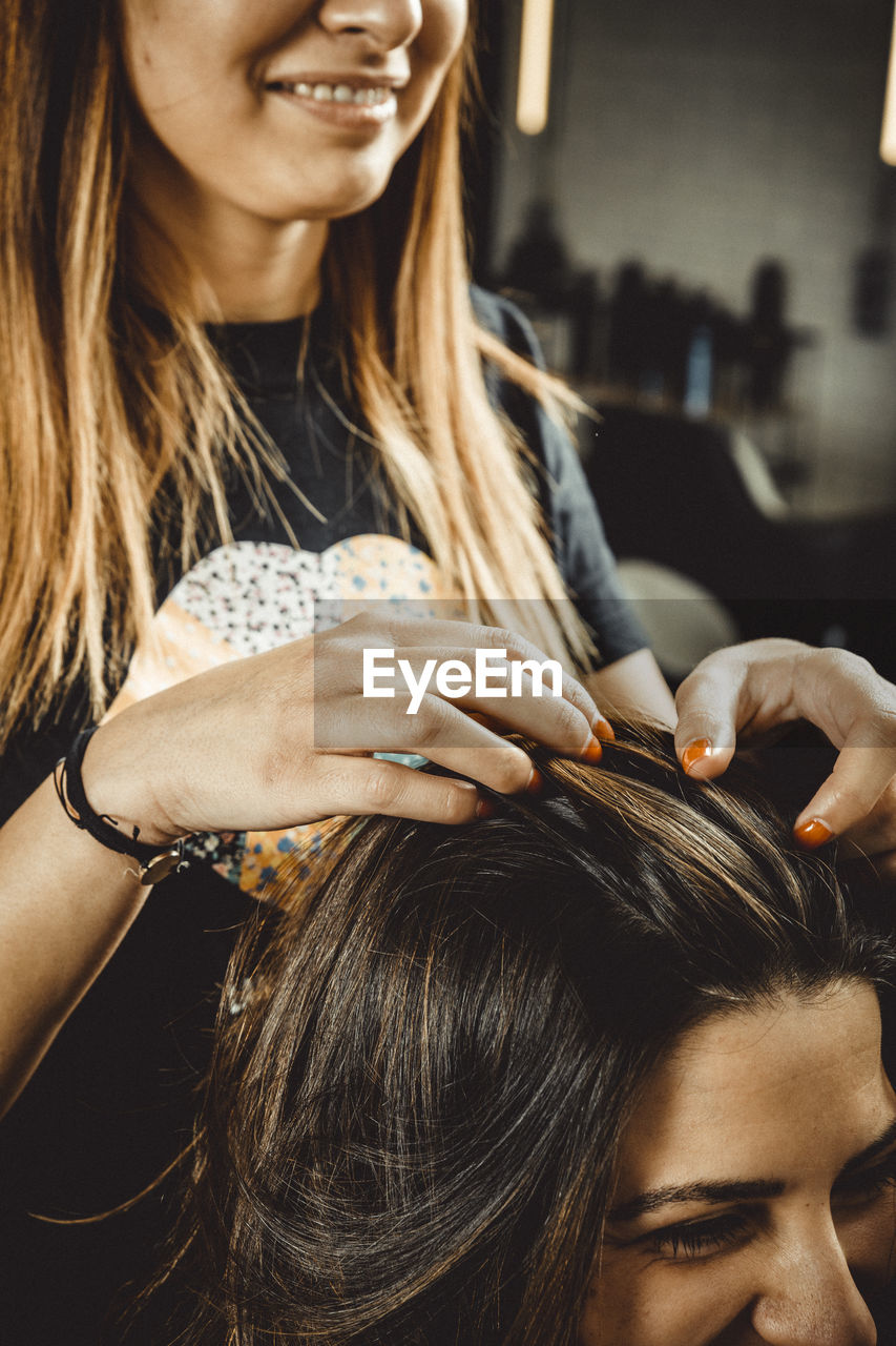 Hairdresser and beautician working in her hair salon