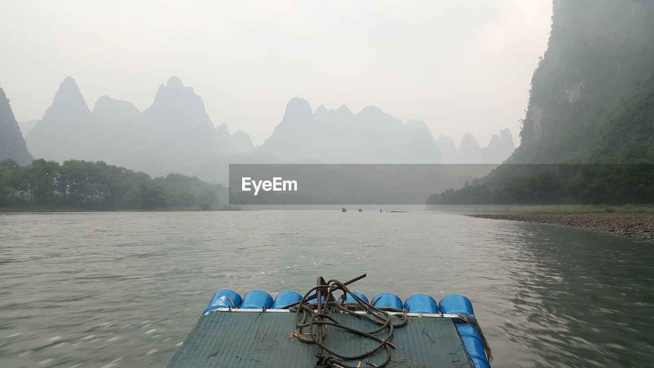 Scenic view of river with mountains in background