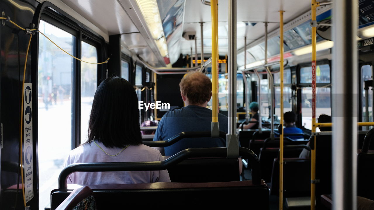 Rear view of people sitting in bus