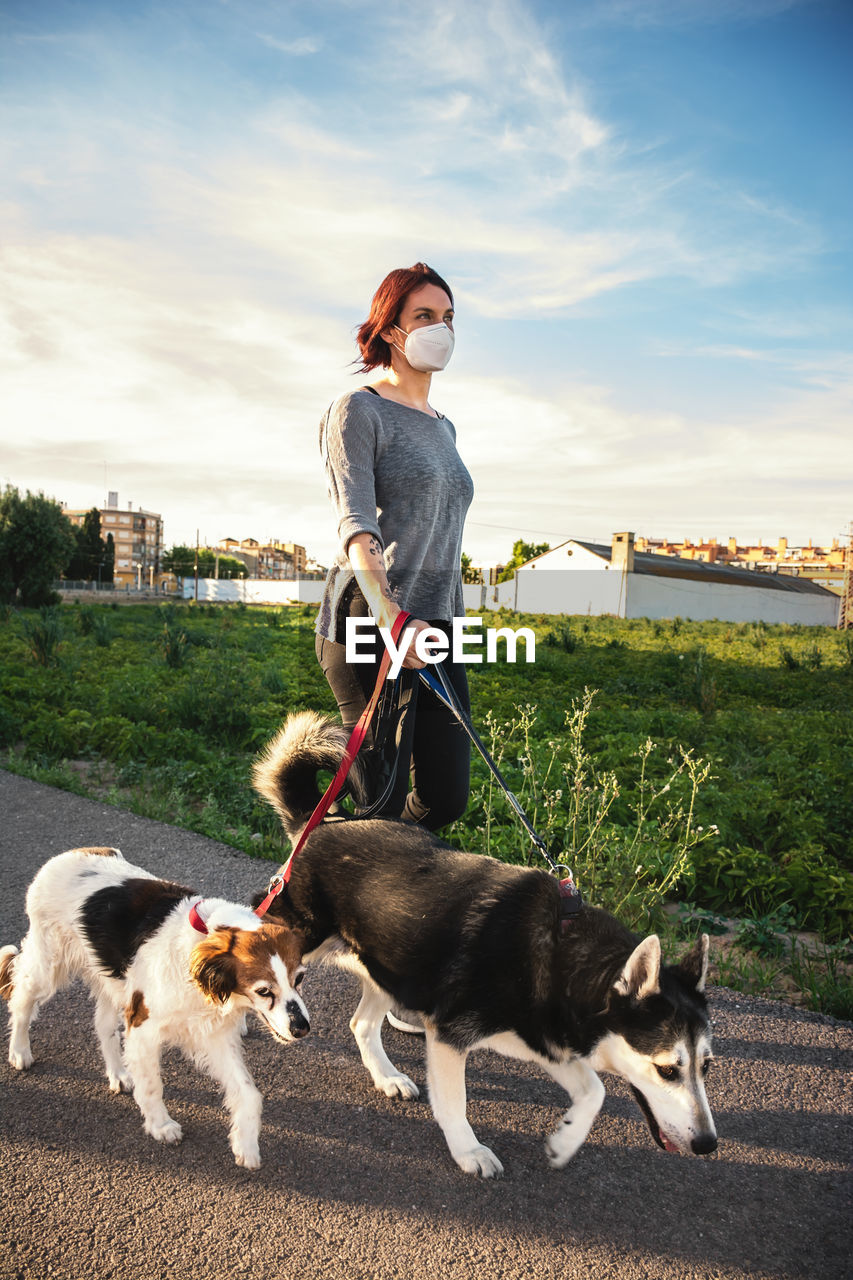 Woman with dog on field