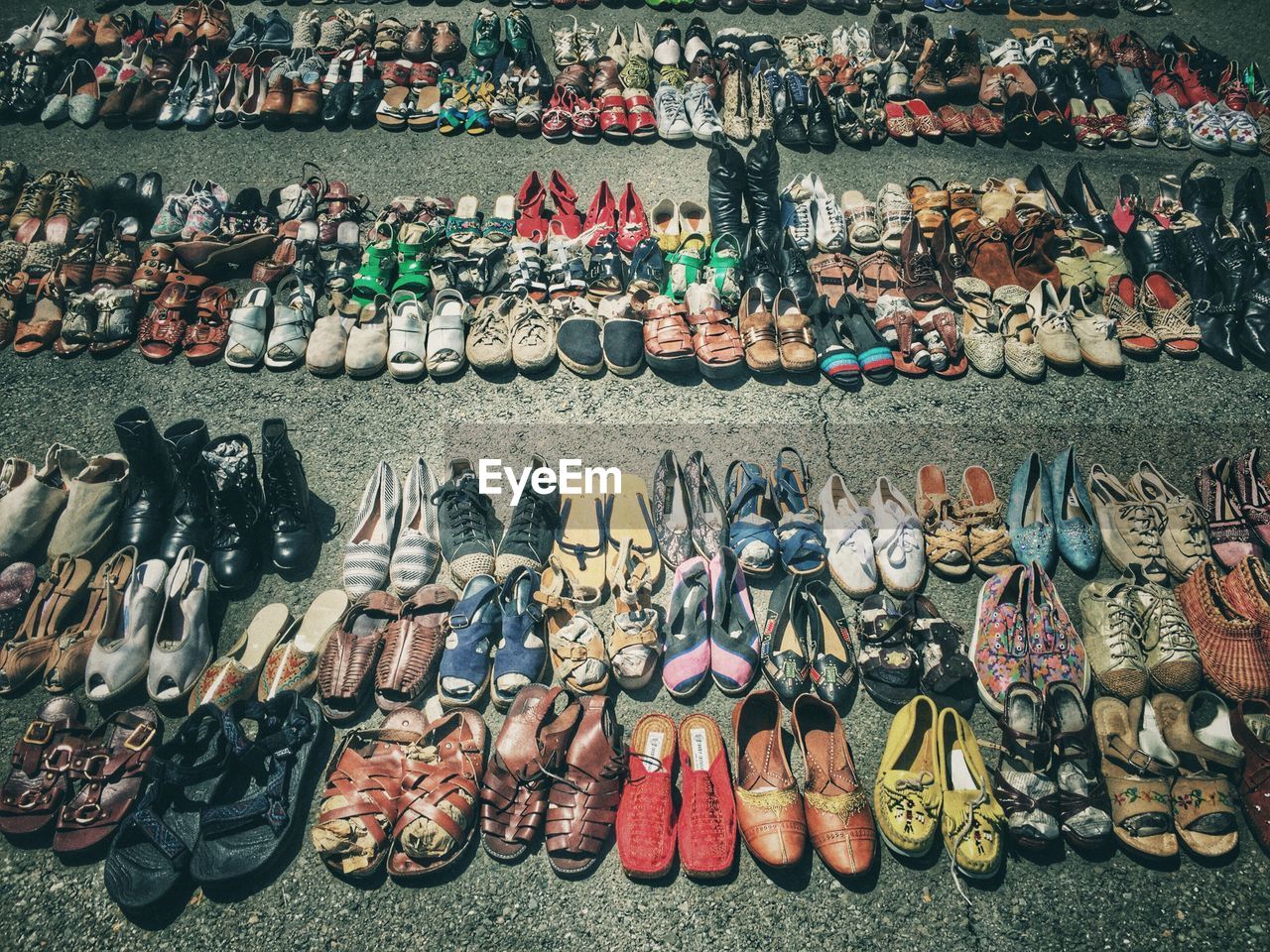 High angle view of footwear for sale at street market on sunny day
