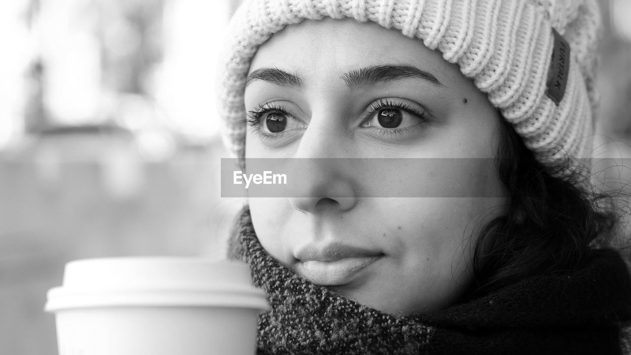 Close-up portrait of woman wearing hat