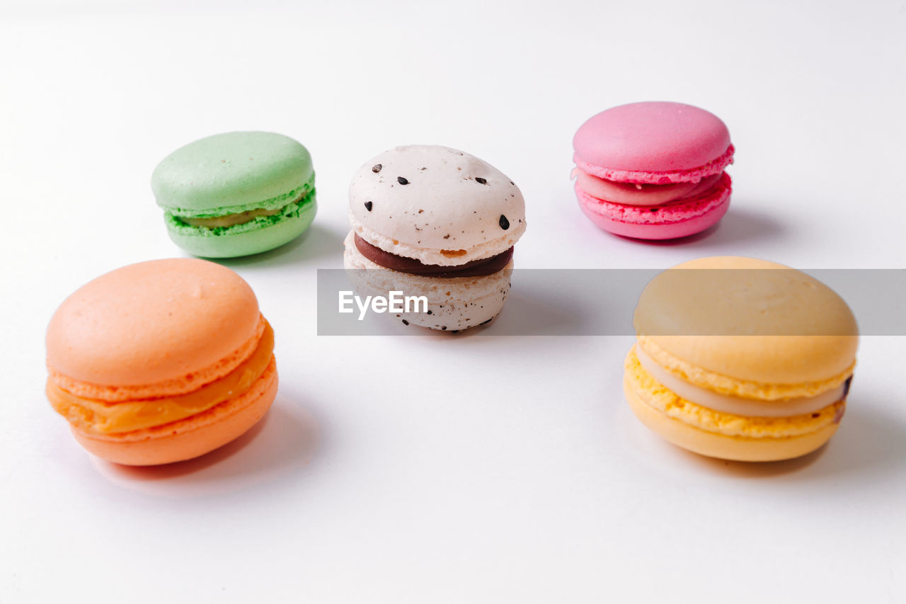 Close-up of multi colored macaroons on white background