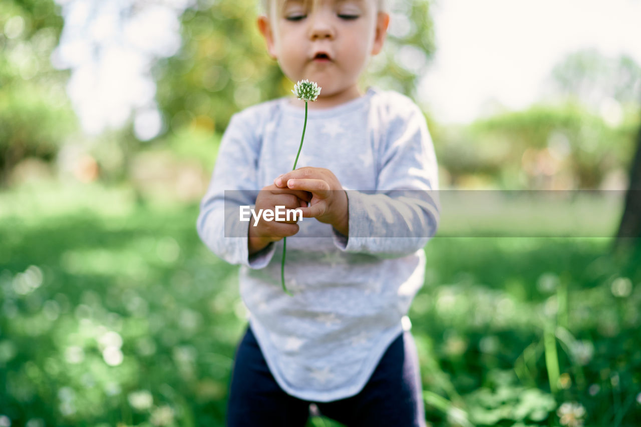 FULL LENGTH OF BOY HOLDING CAMERA