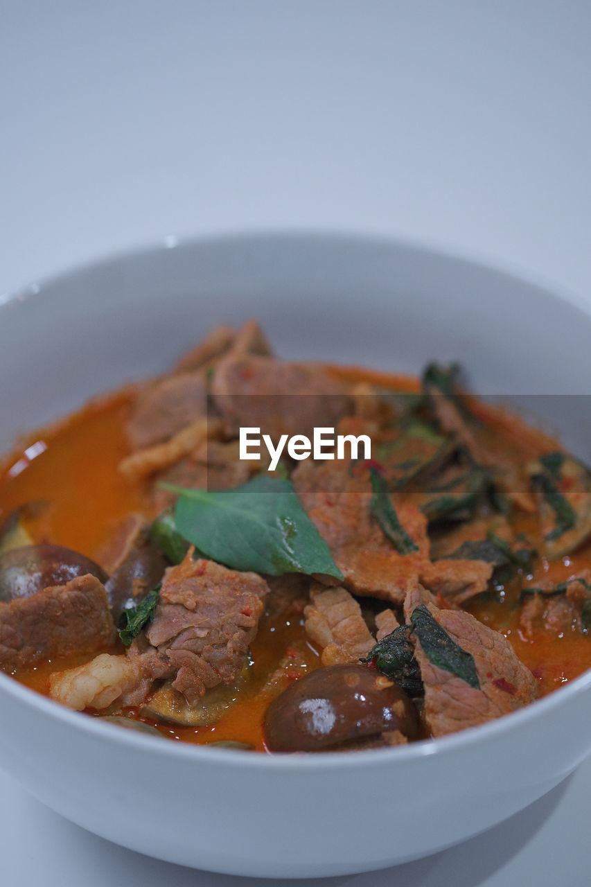 CLOSE-UP OF MEAL SERVED IN BOWL AGAINST WHITE BACKGROUND