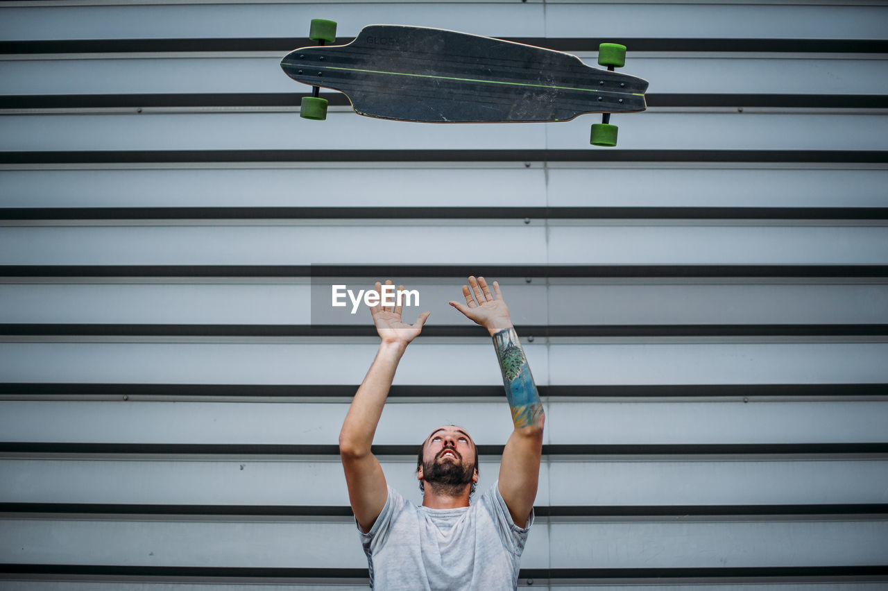 A boy launches skateboard up