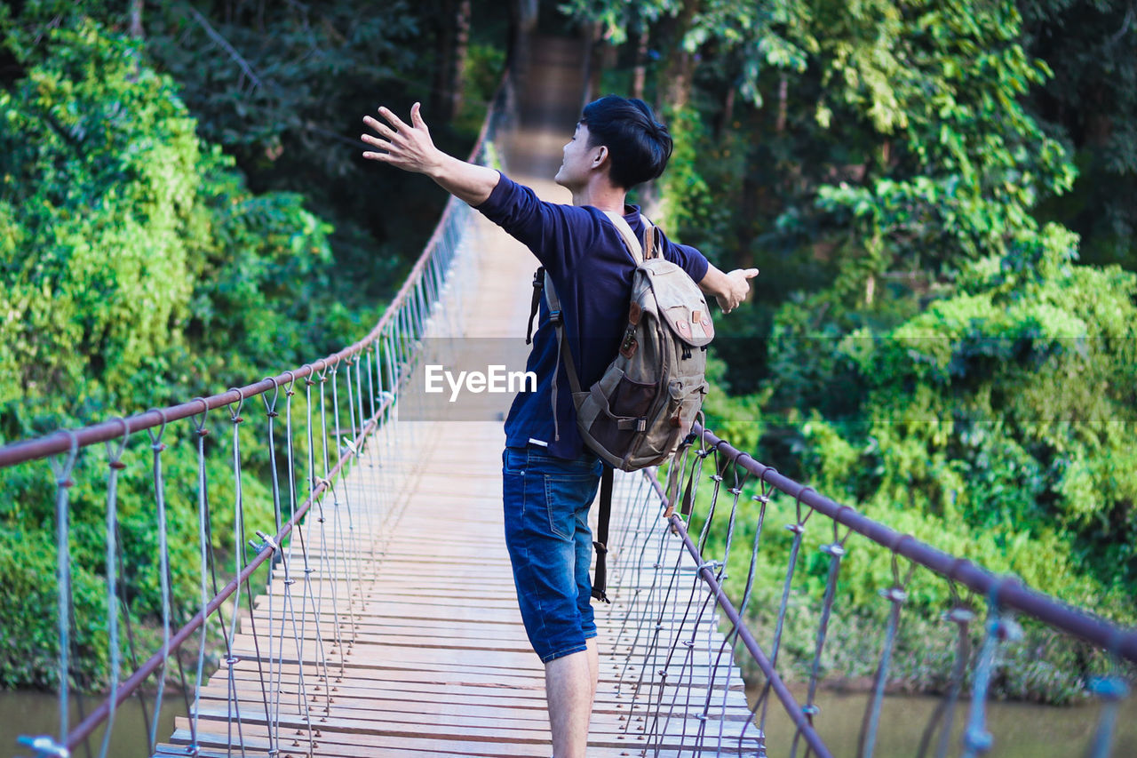 Rear view of woman on footbridge