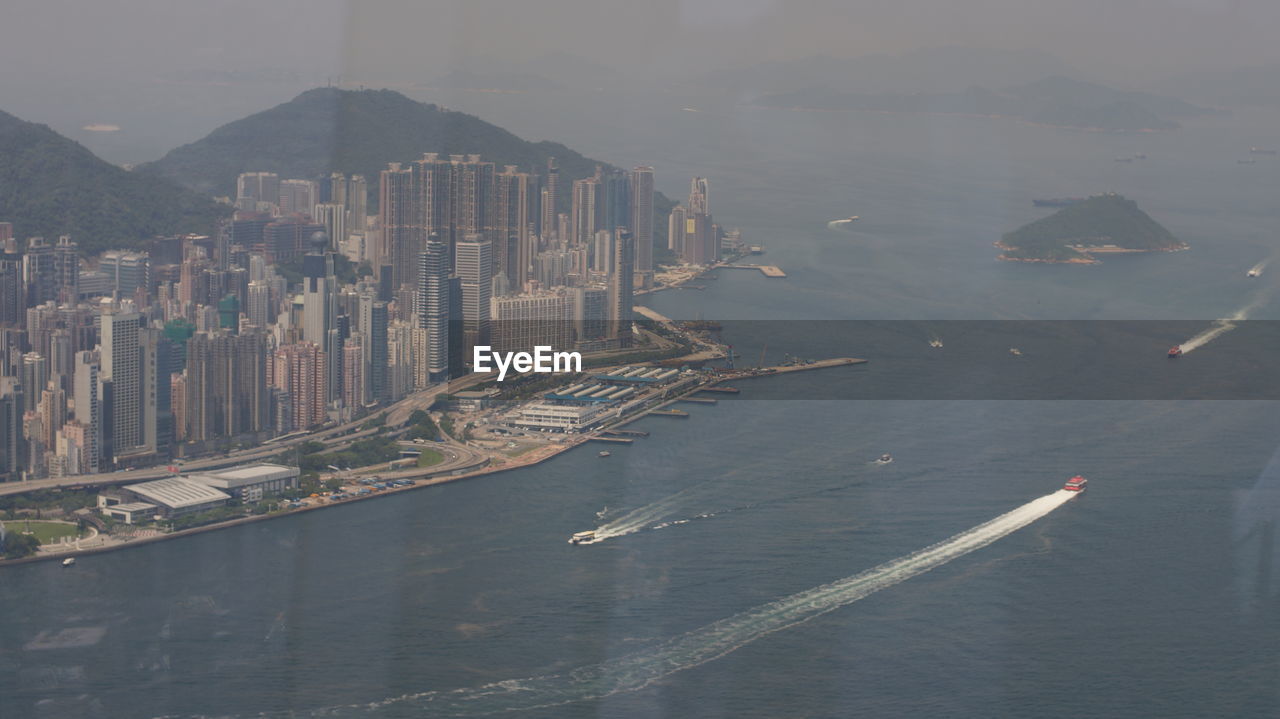 HIGH ANGLE VIEW OF CITY BUILDINGS AND SEA