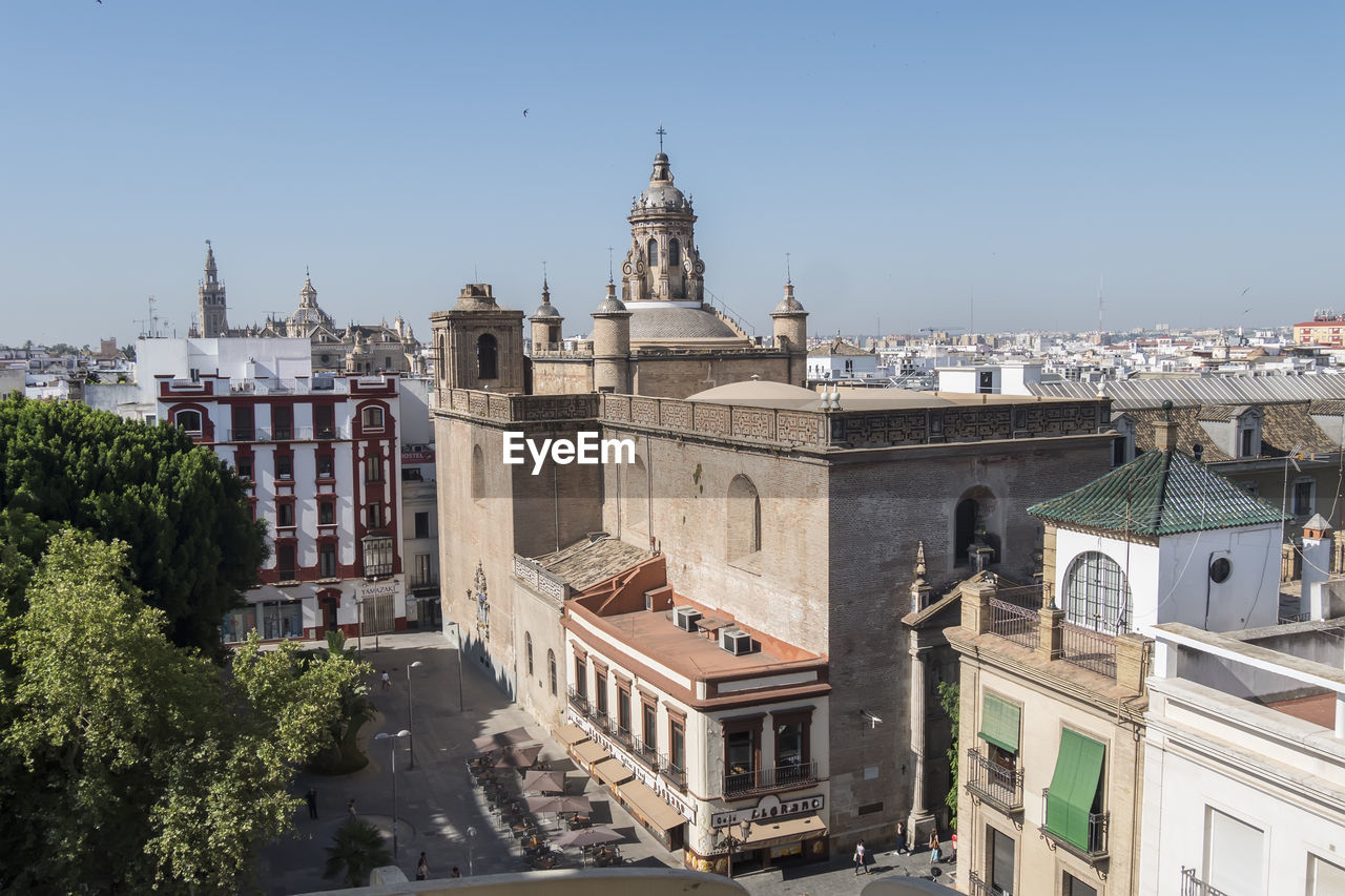 architecture, built structure, building exterior, city, building, town, landmark, travel destinations, sky, nature, place of worship, religion, travel, history, the past, clear sky, cityscape, tower, tourism, high angle view, belief, no people, tree, roof, urban area, sunny, day, outdoors, plant, spirituality, residential district, blue, old, street, town square