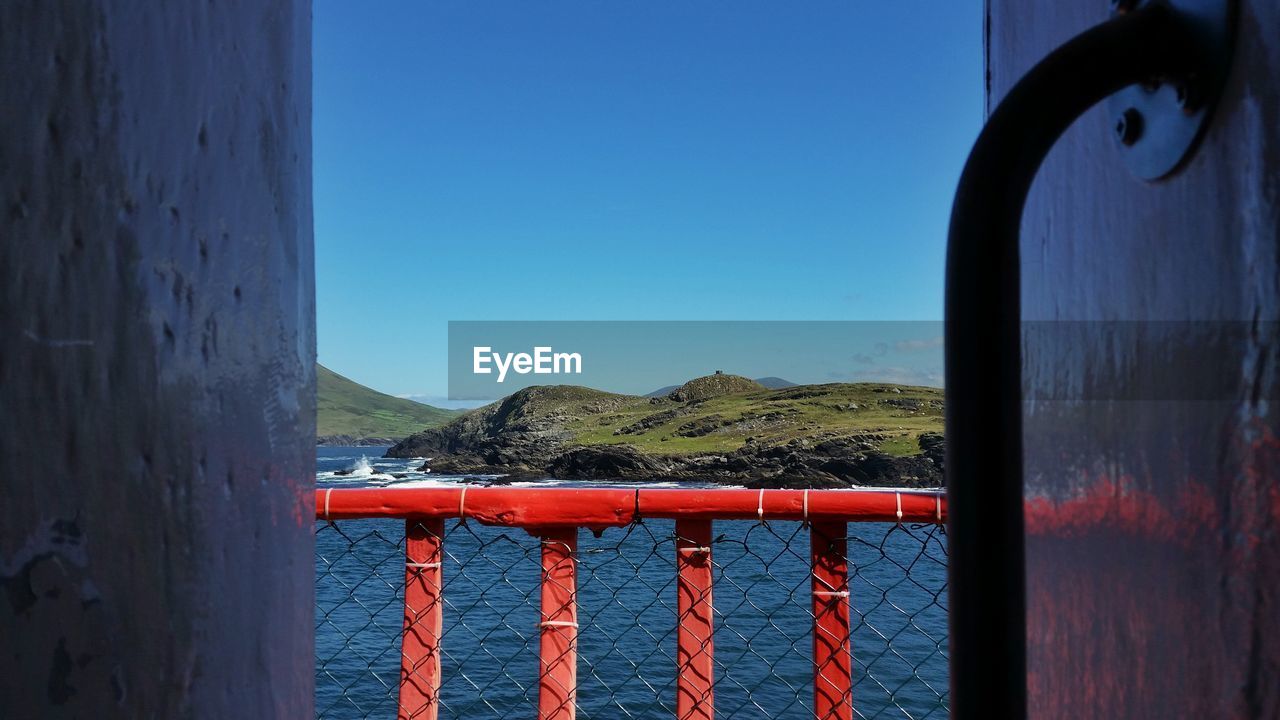 View of calm sea against clear blue sky