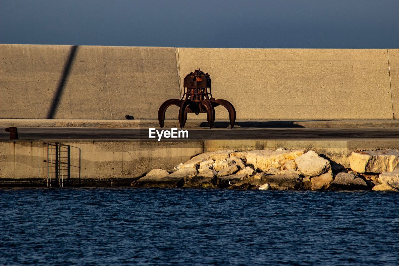 MAN WITH BICYCLE AGAINST SEA