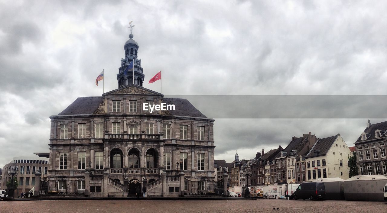 BUILDINGS AGAINST CLOUDY SKY