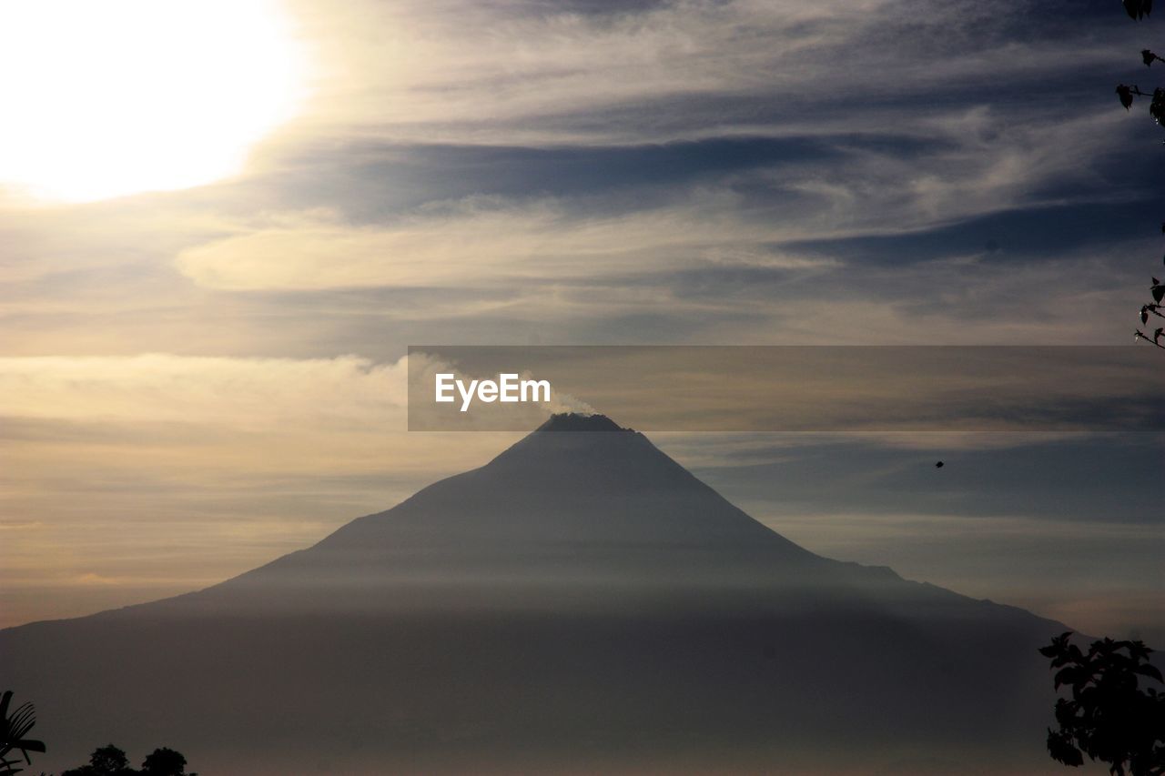 Scenic view of volcano against sky during sunset