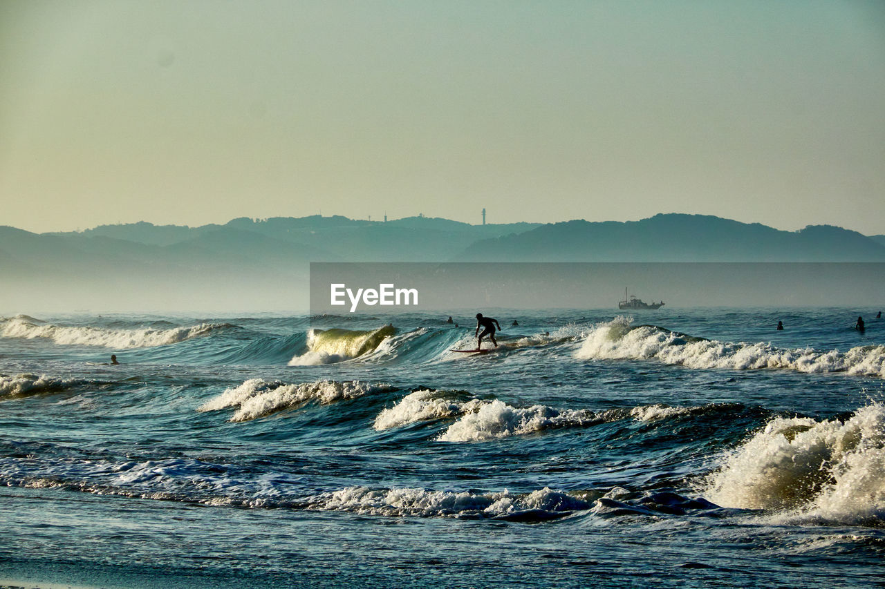 scenic view of sea and mountains against sky