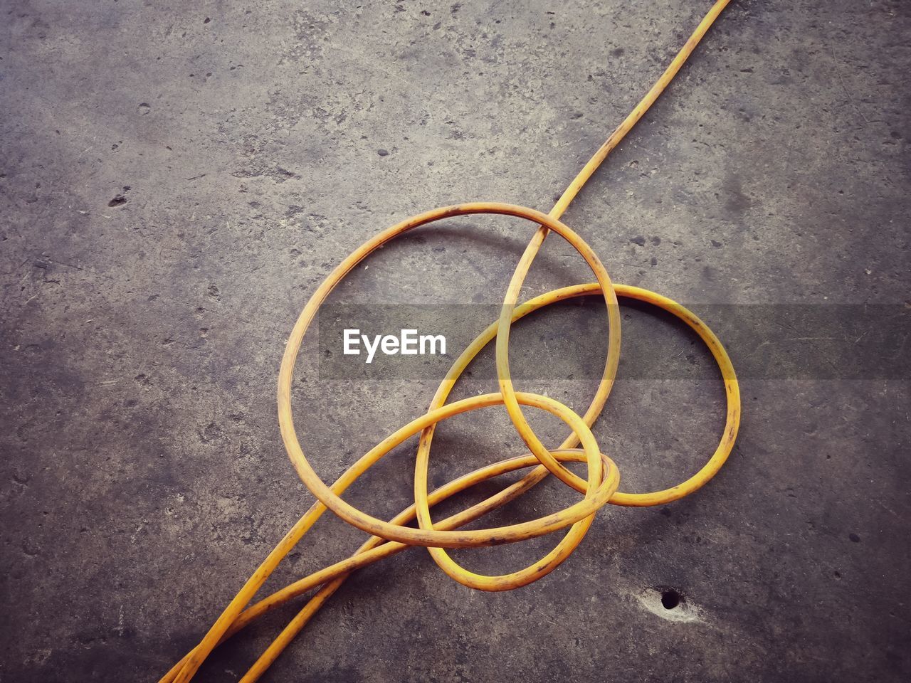 High angle view of yellow cables on concrete