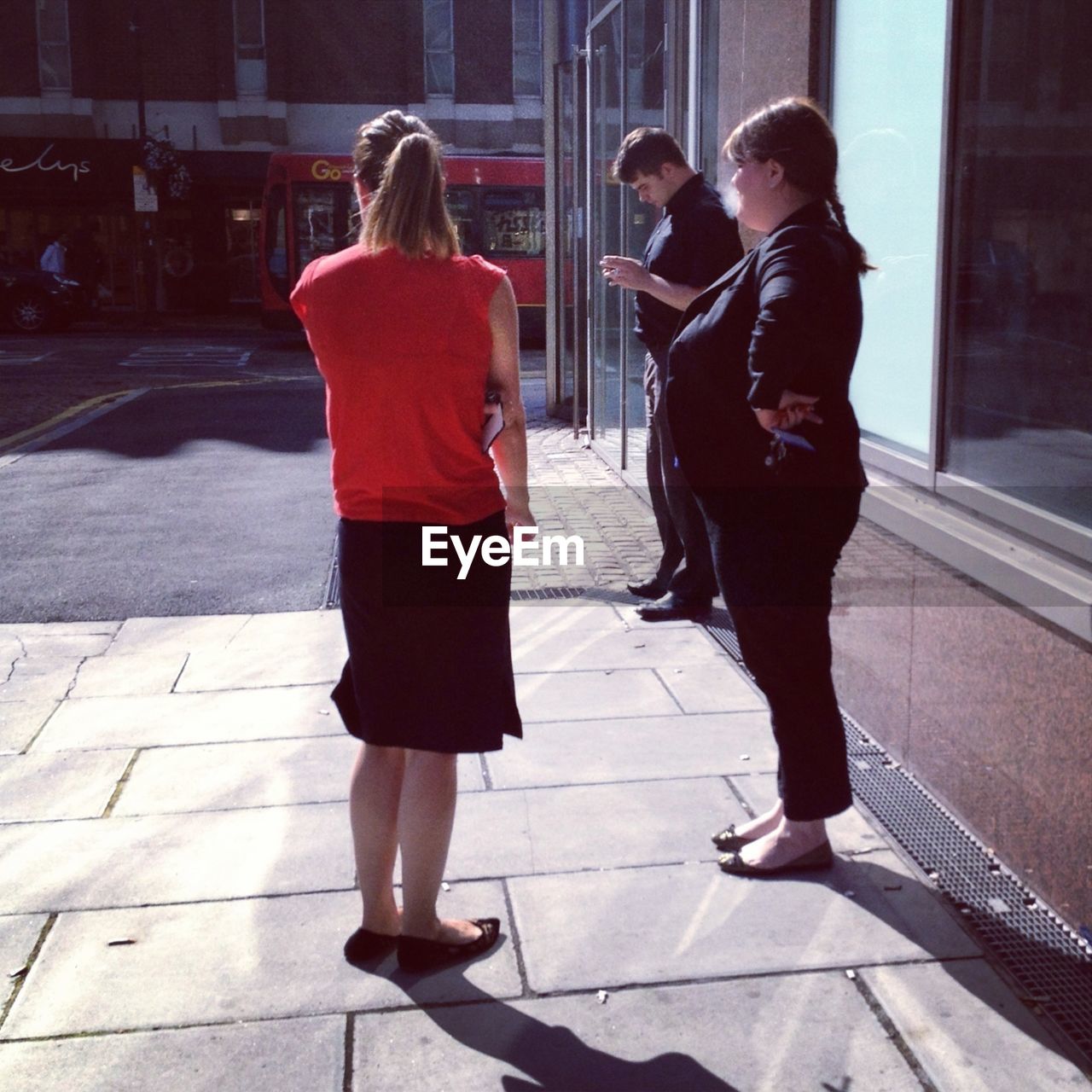 WOMAN WALKING ON SIDEWALK