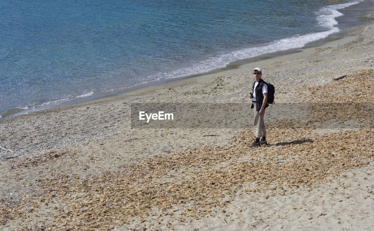 Man standing on sand at beach