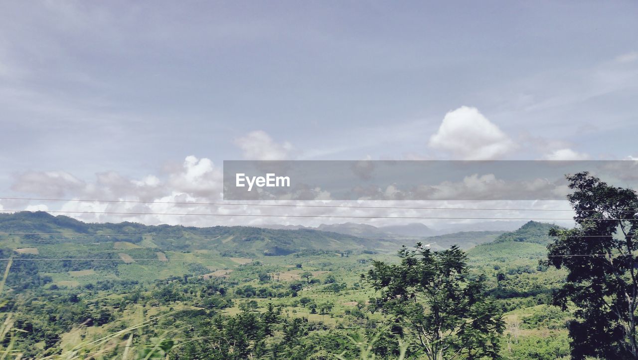 Scenic view of landscape against cloudy sky