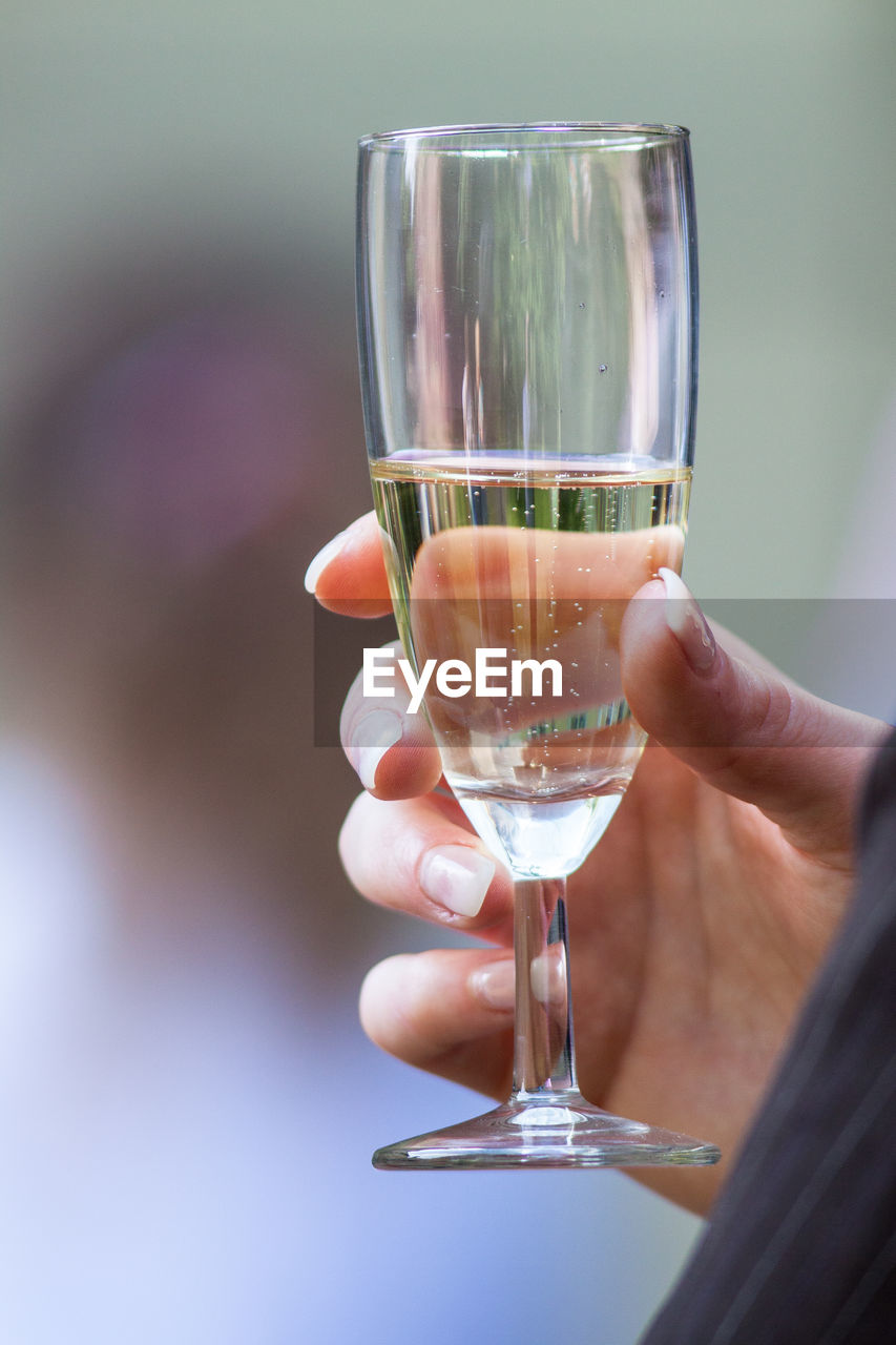 Cropped image of person holding champagne flute