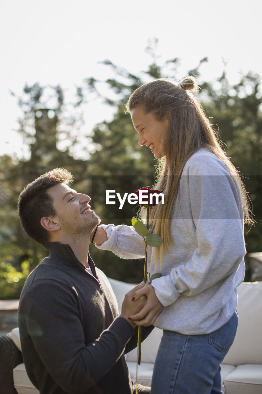 Side view of couple holding hands