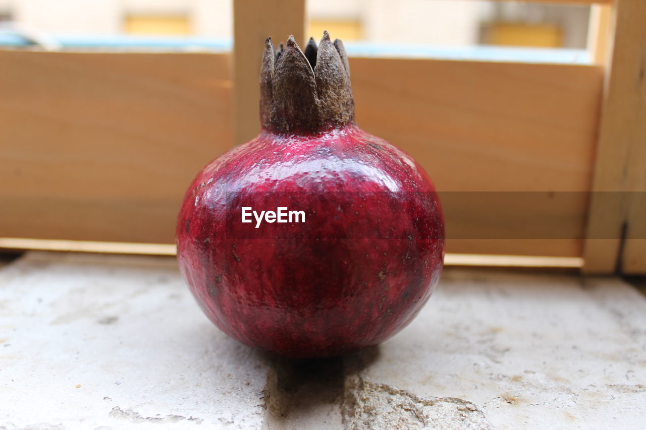 CLOSE-UP OF APPLE ON FLOOR