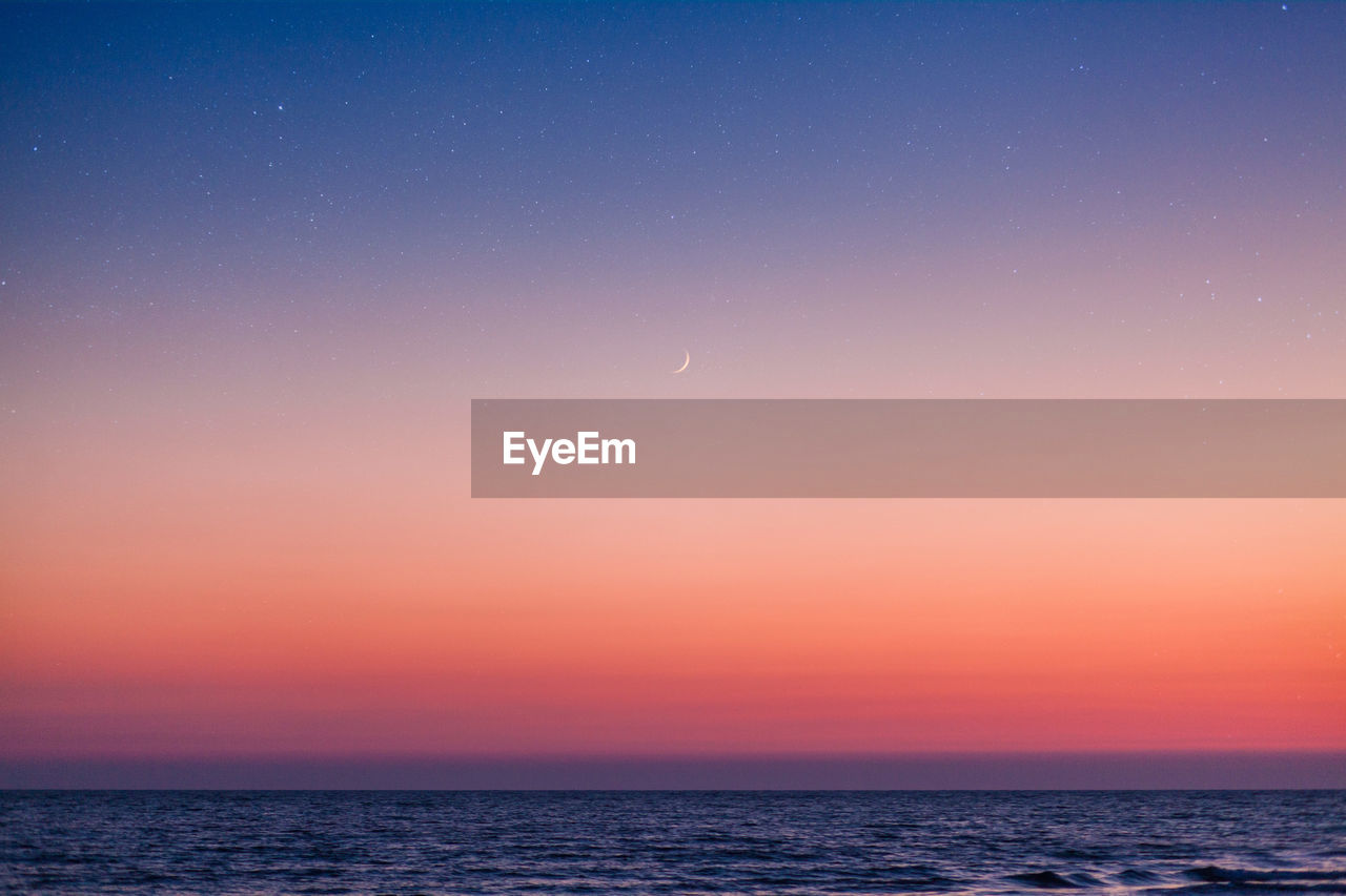 Scenic view of sea against sky at night