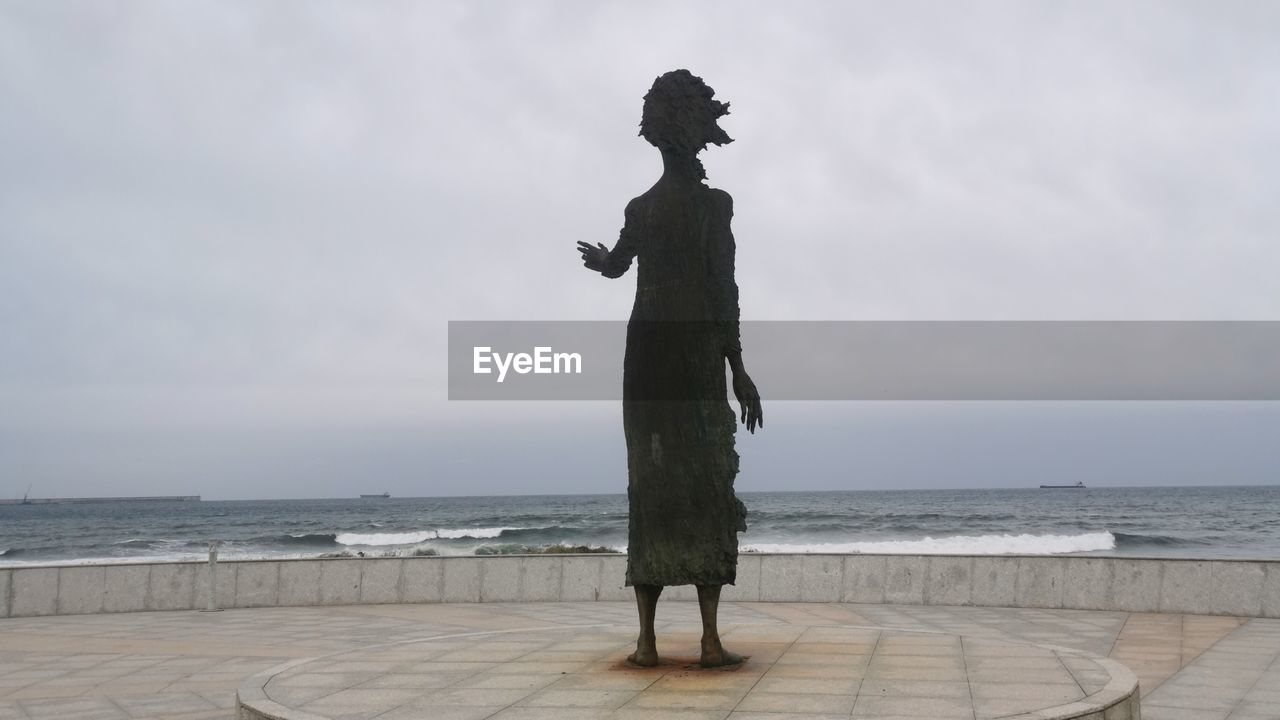 sky, water, sea, horizon over water, statue, full length, nature, one person, horizon, standing, sculpture, cloud, beach, ocean, day, adult, outdoors, land, beauty in nature, architecture, monument, representation, tranquility, travel destinations, coast, human representation, scenics - nature, men