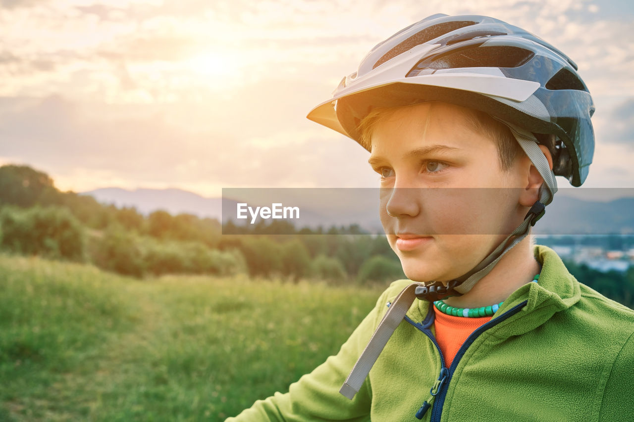 Happy boy to ride bicycle. cute boy in helmet learn to riding a bike in park in summer day.