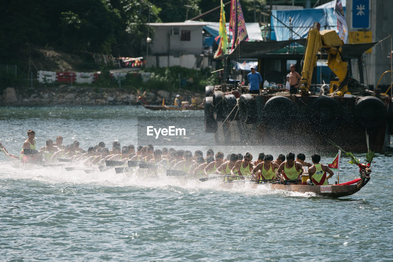 GROUP OF PEOPLE IN BOAT AT SEA