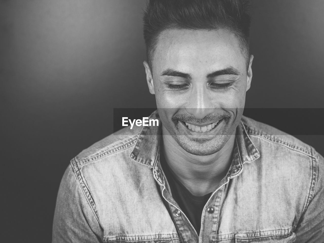 Close-up of smiling young man against gray background