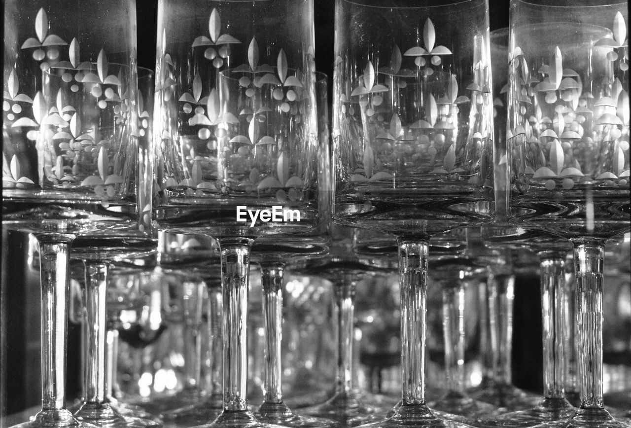 FULL FRAME SHOT OF GLASS BOTTLES ON TABLE IN BAR