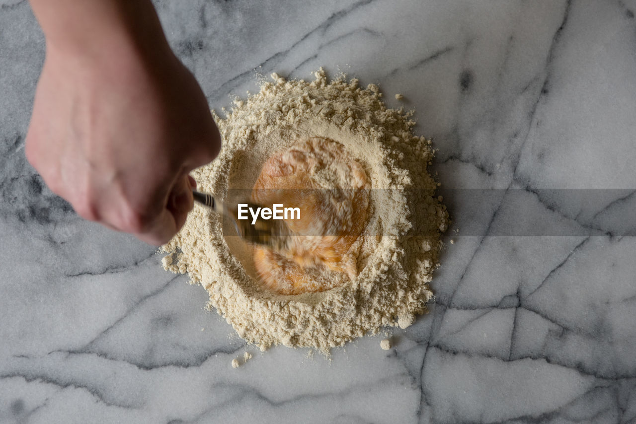 Cropped image of person preparing food