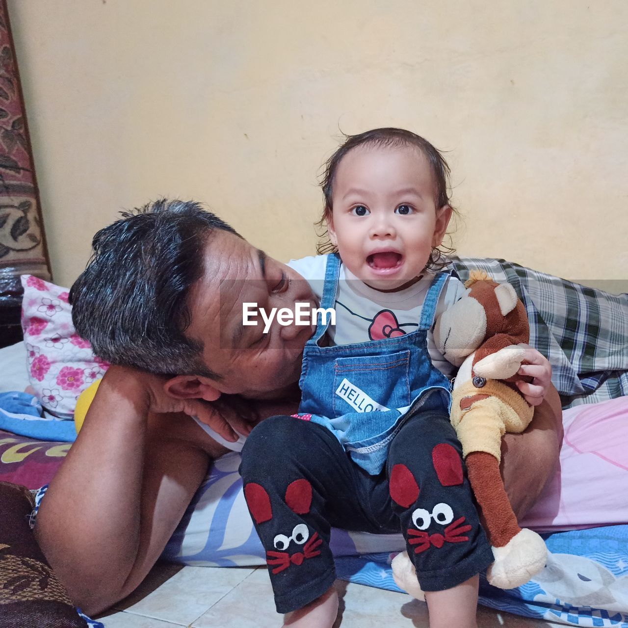 PORTRAIT OF CUTE MOTHER AND BABY AT HOME